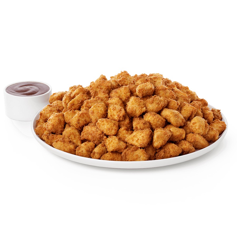 Chick-fil-A catering trays of nuggets, sandwiches and sides laid out for a group.